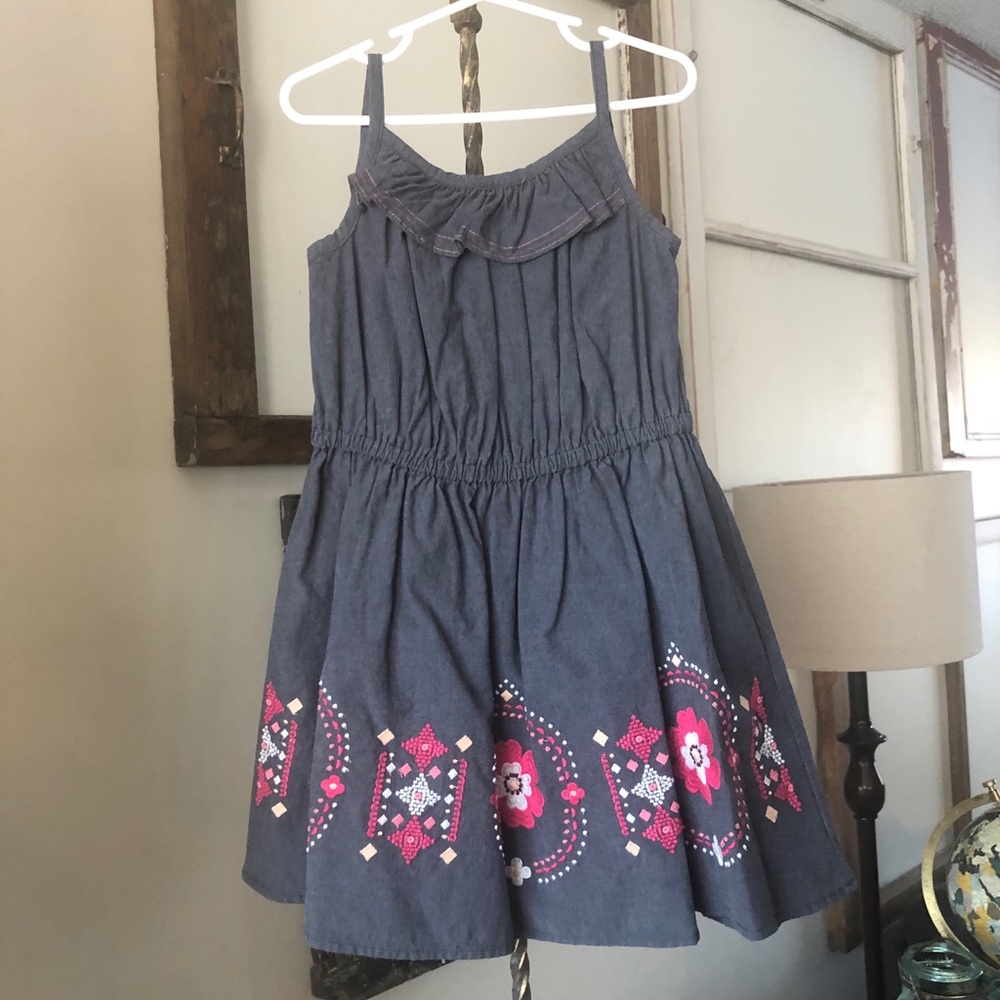 Girl’s denim dress with floral edging, size 6.